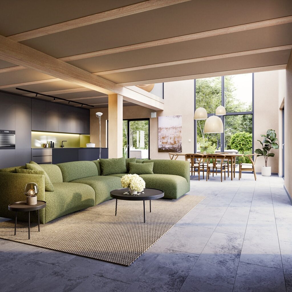 Offener Wohnbereich mit grünem Ecksofa, runden Couchtischen, moderner Küche mit schwarzen Schränken und großem Essbereich vor bodentiefen Fenstern.